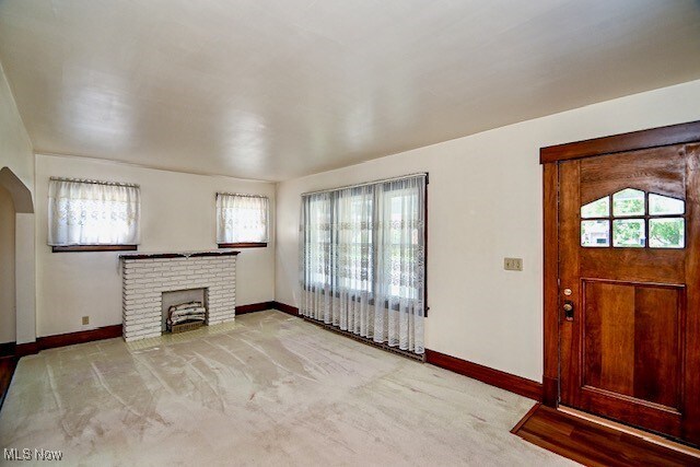 837 Lake Ave NE, Massillon, OH 44646 - unfurnished living room with plenty of natural light and baseboards
