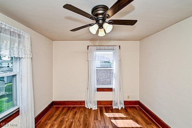 837 Lake Ave NE, Massillon, OH 44646 - empty room with baseboards, wood finished floors, and a ceiling fan