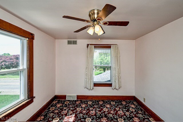 837 Lake Ave NE, Massillon, OH 44646 - unfurnished room with baseboards, ceiling fan, and wood finished floors