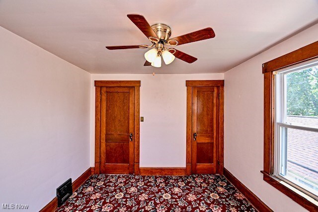 837 Lake Ave NE, Massillon, OH 44646 - spare room featuring baseboards and ceiling fan