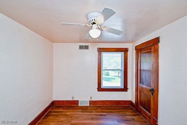837 Lake Ave NE, Massillon, OH 44646 - empty room featuring baseboards, wood finished floors, and a ceiling fan
