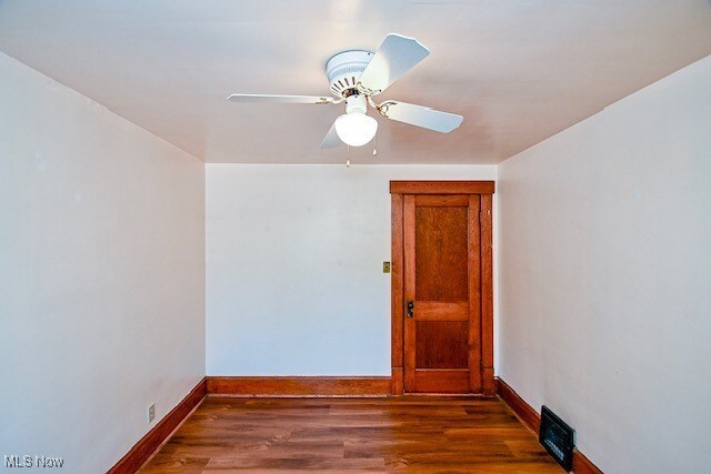837 Lake Ave NE, Massillon, OH 44646 - unfurnished room featuring baseboards, wood finished floors, and a ceiling fan