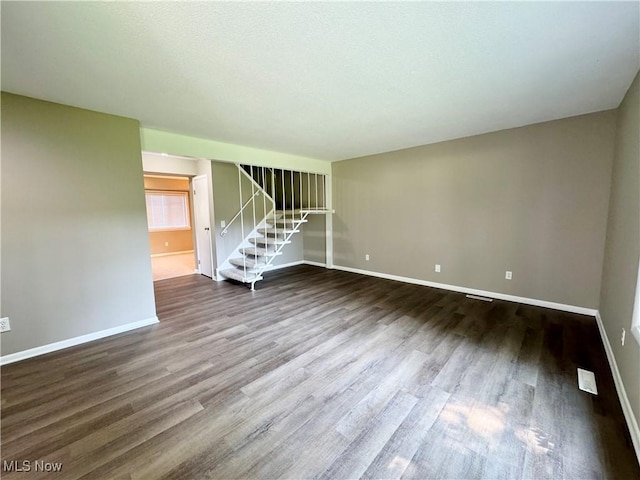 6400 Center St Unit 14, Mentor, OH 44060 - unfurnished living room with wood finished floors, baseboards, and stairway