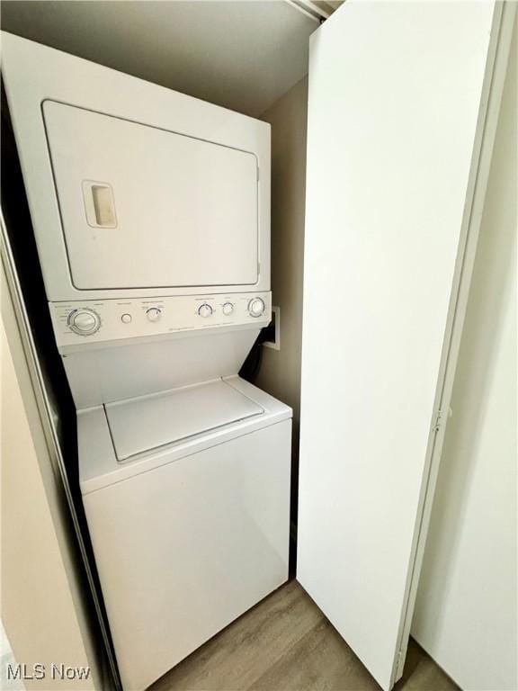 6400 Center St Unit 14, Mentor, OH 44060 - laundry room with stacked washer and clothes dryer and light wood-style floors