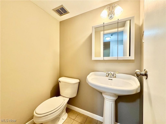 6400 Center St Unit 14, Mentor, OH 44060 - half bathroom featuring toilet, tile patterned floors, and baseboards