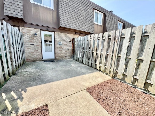 6400 Center St Unit 14, Mentor, OH 44060 - property entrance featuring brick siding, mansard roof, a patio area, and a shingled roof