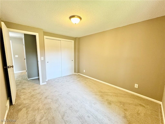 6400 Center St Unit 14, Mentor, OH 44060 - unfurnished bedroom with carpet floors, a closet, a textured ceiling, and baseboards