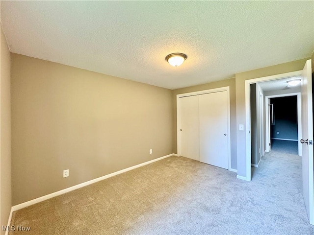 6400 Center St Unit 14, Mentor, OH 44060 - unfurnished bedroom featuring carpet floors, a closet, a textured ceiling, and baseboards