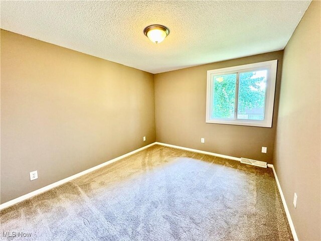 6400 Center St Unit 14, Mentor, OH 44060 - carpeted spare room with baseboards and a textured ceiling