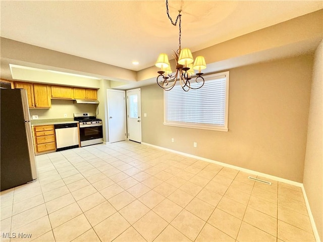 6400 Center St Unit 14, Mentor, OH 44060 - kitchen with appliances with stainless steel finishes, under cabinet range hood, a chandelier, baseboards, and light tile patterned floors