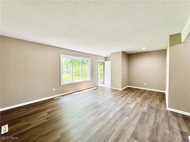 6400 Center St Unit 14, Mentor, OH 44060 - empty room featuring dark wood finished floors, baseboards, and a textured ceiling