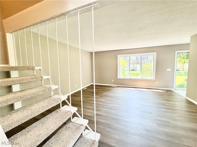 6400 Center St Unit 14, Mentor, OH 44060 - stairs featuring wood finished floors, baseboards, and a textured ceiling
