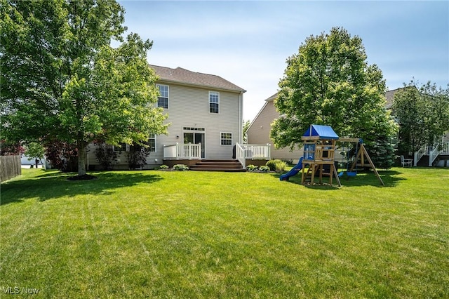 3079 Landing Ln, Reminderville, OH 44202 - back of house featuring a playground, a lawn, and a wooden deck