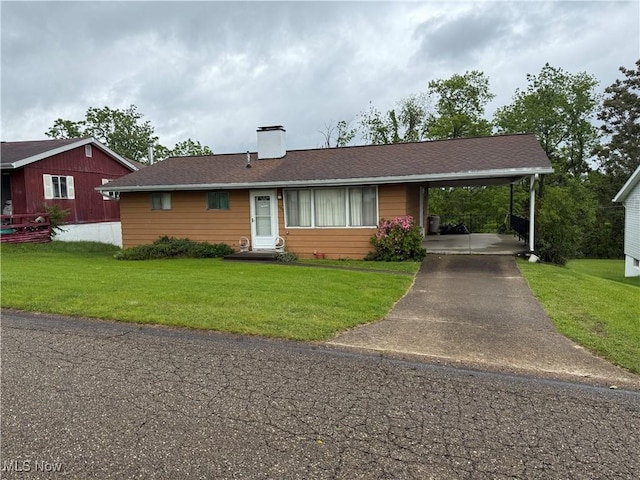 156 Andover Rd, Woodsfield, OH 43793 - ranch-style home with concrete driveway, an attached carport, a front yard, and a chimney
