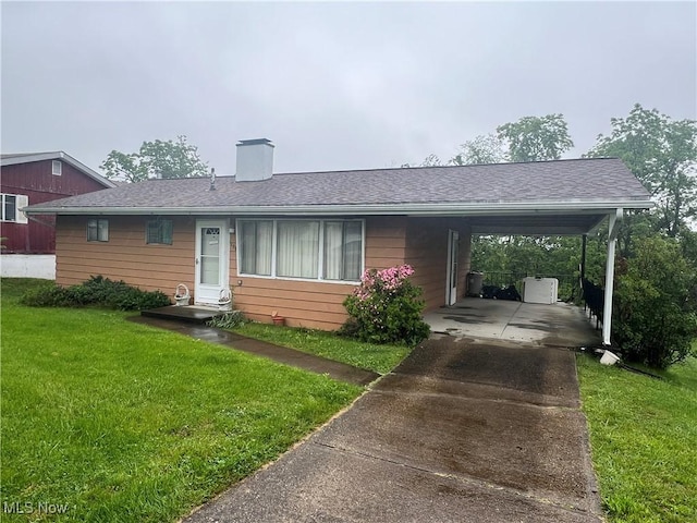 156 Andover Rd, Woodsfield, OH 43793 - single story home with a front yard, concrete driveway, an attached carport, a chimney, and roof with shingles