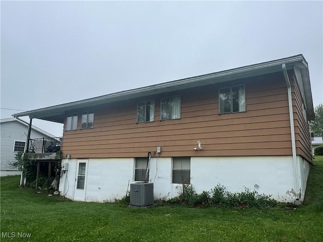 156 Andover Rd, Woodsfield, OH 43793 - back of property featuring central AC and a yard