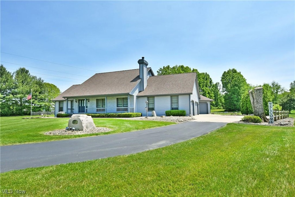 11120 King Graves Rd NE, Warren, OH 44484 - view of front of property featuring a chimney, a front lawn, and a garage