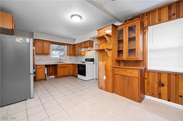 348 Elberta Dr, Vermilion, OH 44089 - kitchen with range with electric stovetop, freestanding refrigerator, brown cabinets, light countertops, and under cabinet range hood