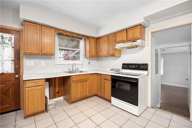 348 Elberta Dr, Vermilion, OH 44089 - kitchen featuring electric range, under cabinet range hood, a sink, light countertops, and brown cabinets