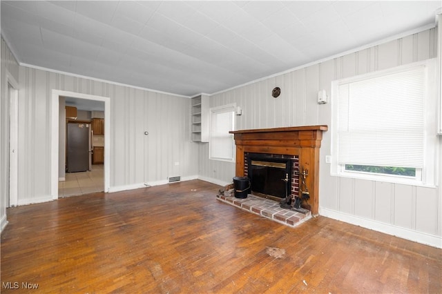 348 Elberta Dr, Vermilion, OH 44089 - unfurnished living room featuring hardwood / wood-style flooring, crown molding, baseboards, and a fireplace
