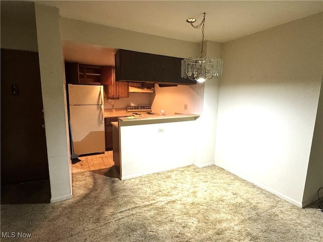 2540 N River Rd NE Unit C7, Warren, OH 44483 - kitchen with freestanding refrigerator, light carpet, light countertops, range, and a peninsula