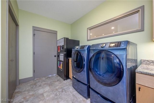 4340 Castlegate Blvd, Uniontown, OH 44685 - laundry area with washer and clothes dryer, cabinet space, and baseboards