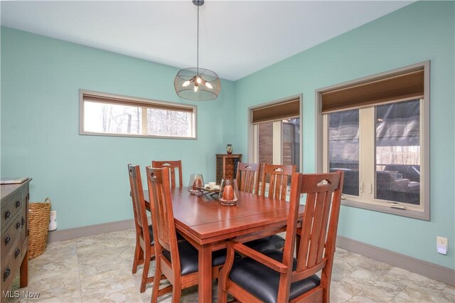 4340 Castlegate Blvd, Uniontown, OH 44685 - dining space with baseboards and a chandelier