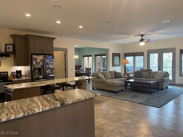 4340 Castlegate Blvd, Uniontown, OH 44685 - living area with recessed lighting, ceiling fan, and french doors