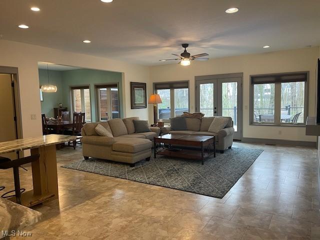 4340 Castlegate Blvd, Uniontown, OH 44685 - living room with recessed lighting, plenty of natural light, a ceiling fan, french doors, and baseboards