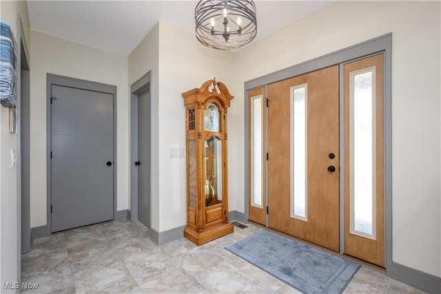 4340 Castlegate Blvd, Uniontown, OH 44685 - entrance foyer featuring a chandelier and baseboards