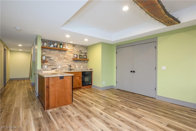4340 Castlegate Blvd, Uniontown, OH 44685 - indoor wet bar featuring black oven, light wood-style floors, baseboards, recessed lighting, and a raised ceiling
