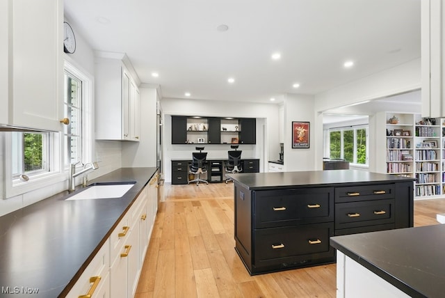 19 Brandywood Dr, Pepper Pike, OH 44124 - kitchen with dark cabinets, a sink, dark countertops, white cabinets, and light wood-style flooring