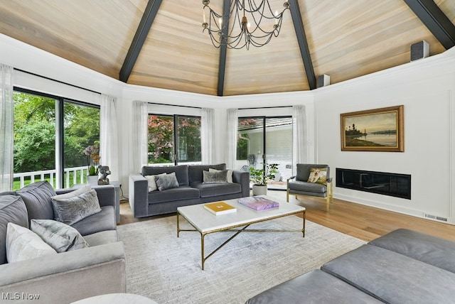 19 Brandywood Dr, Pepper Pike, OH 44124 - living room featuring wood ceiling with exposed beams, healthy amount of natural light, a chandelier, wood finished floors, and high vaulted ceiling