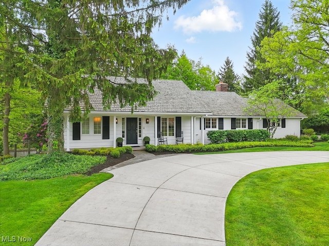 19 Brandywood Dr, Pepper Pike, OH 44124 - view of front of home featuring a chimney, covered porch, a front lawn, and curved driveway