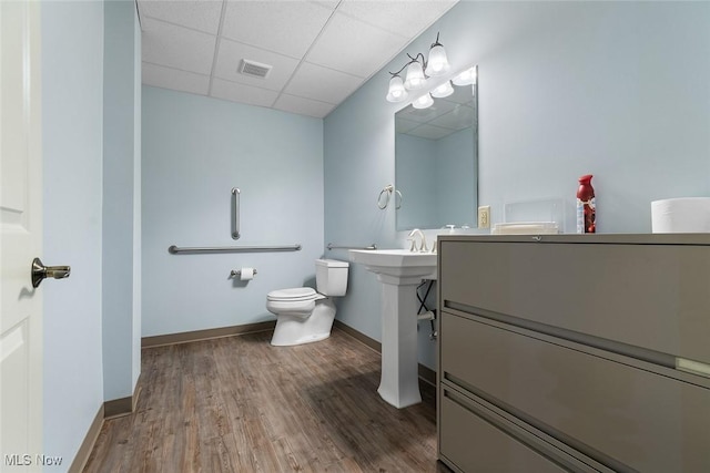 5495 Meese Rd NE, Louisville, OH 44641 - bathroom with a drop ceiling, toilet, wood finished floors, and baseboards