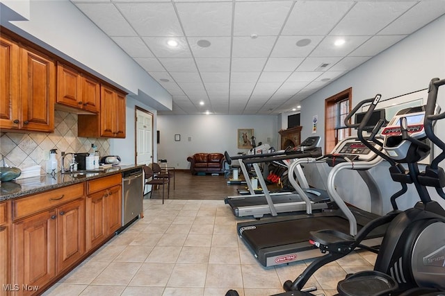 5495 Meese Rd NE, Louisville, OH 44641 - workout area featuring a sink, a paneled ceiling, recessed lighting, and light tile patterned floors
