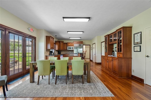 5495 Meese Rd NE, Louisville, OH 44641 - dining area featuring wood finished floors, baseboards, and french doors