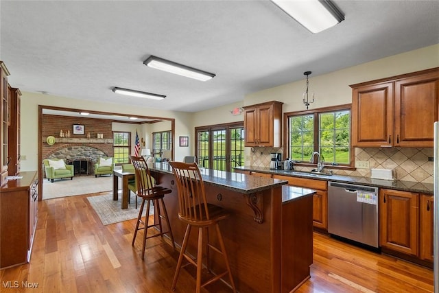 5495 Meese Rd NE, Louisville, OH 44641 - kitchen featuring stainless steel dishwasher, a sink, and brown cabinets