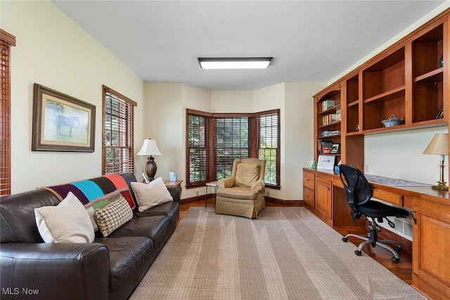 5495 Meese Rd NE, Louisville, OH 44641 - office area featuring built in desk, light wood-style floors, plenty of natural light, and baseboards
