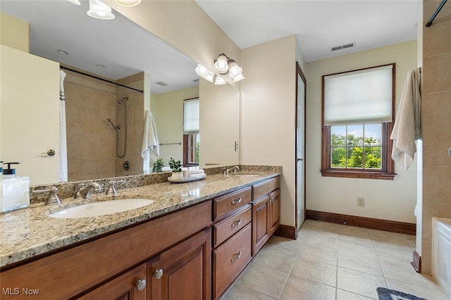 5495 Meese Rd NE, Louisville, OH 44641 - full bathroom featuring double vanity, baseboards, tiled shower, and tile patterned flooring