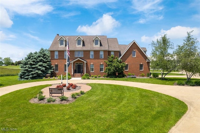 5495 Meese Rd NE, Louisville, OH 44641 - view of front of property with curved driveway, a front lawn, brick siding, and a chimney