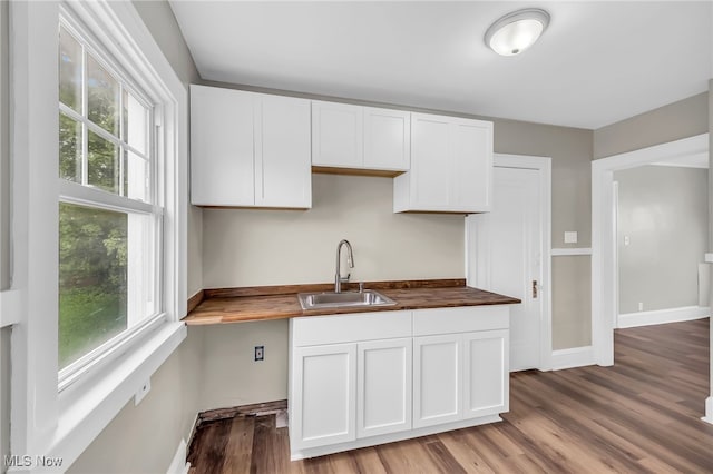 3528 Daleford Rd, Shaker Heights, OH 44120 - kitchen featuring a sink, wooden counters, wood finished floors, and white cabinets