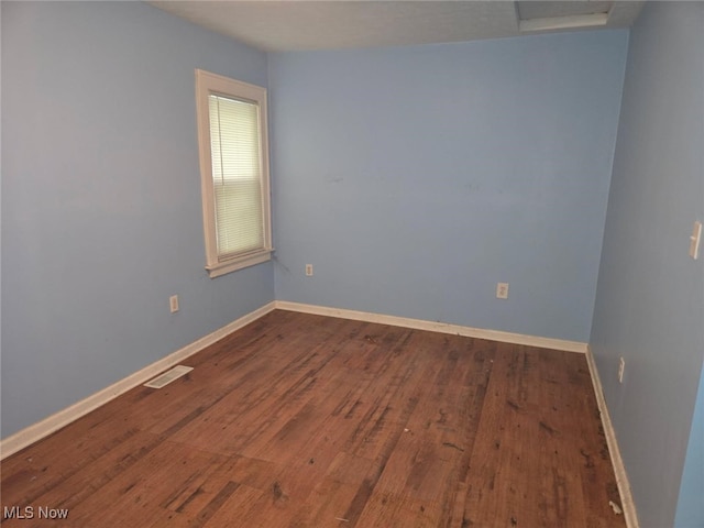 332 Stull Ave, Akron, OH 44312 - empty room with dark wood-style floors and baseboards