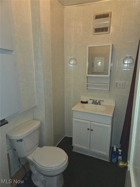 332 Stull Ave, Akron, OH 44312 - half bathroom featuring tile walls, vanity, and toilet
