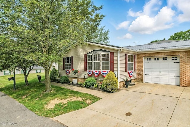 1270 S Lincoln Ave Unit A, Salem, OH 44460 - view of front facade with an attached garage, driveway, metal roof, brick siding, and a front yard