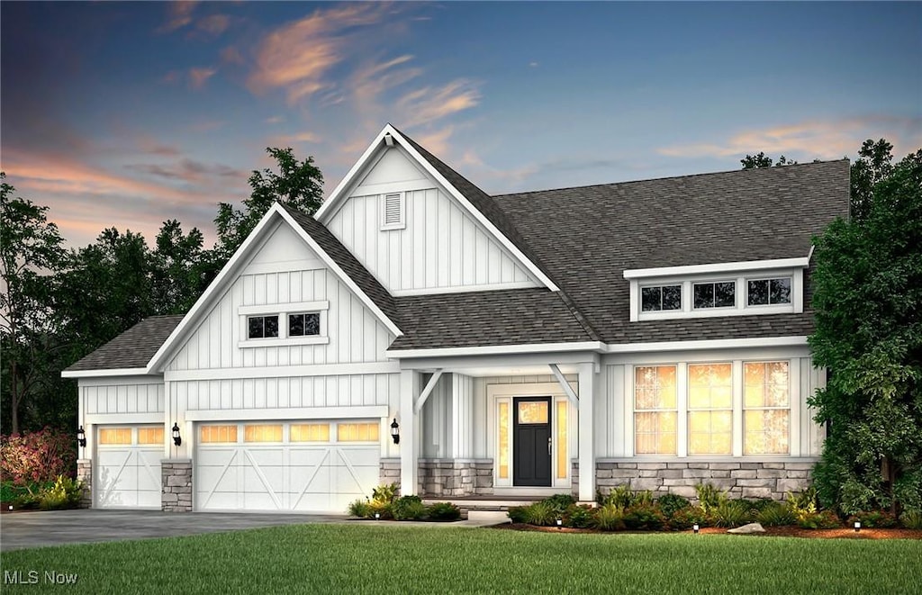 640 Lake Placid Ct, Orange, OH 44022 - modern farmhouse with board and batten siding, stone siding, roof with shingles, and a lawn