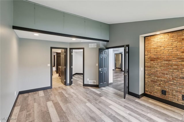 322 N Bayshore Dr Unit 3, Columbiana, OH 44408 - spare room featuring light wood finished floors, baseboards, brick wall, and recessed lighting