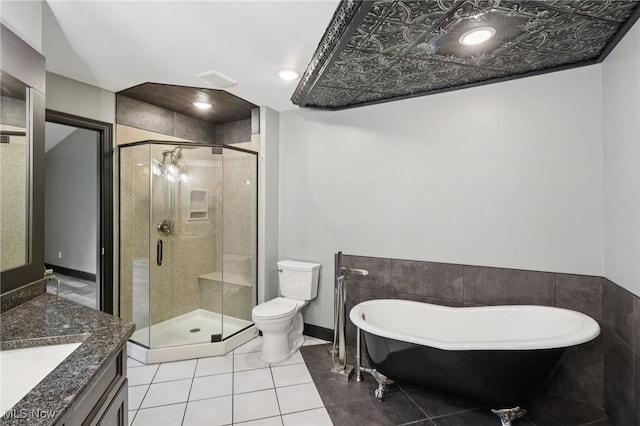 322 N Bayshore Dr Unit 3, Columbiana, OH 44408 - bathroom with vanity, a soaking tub, toilet, a stall shower, and tile patterned floors