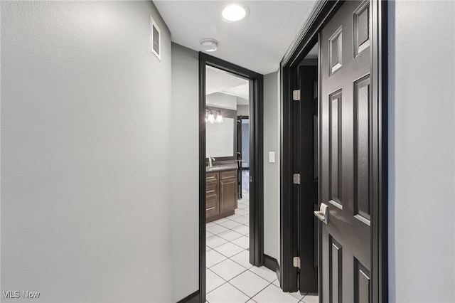 322 N Bayshore Dr Unit 3, Columbiana, OH 44408 - hallway with light tile patterned flooring, baseboards, and a sink