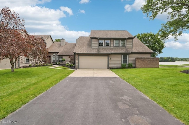 322 N Bayshore Dr Unit 3, Columbiana, OH 44408 - view of front facade with asphalt driveway, a front lawn, and a shingled roof